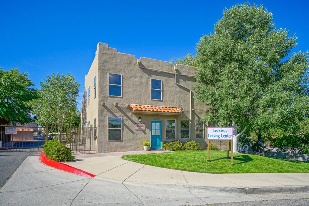 A building with a sign that says "Las Rivas" is in front of a tree.